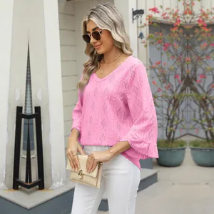 Detailed shot of pink V-neck hollow jacquard top featuring stylish bell sleeves for women