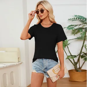 Close-up detail of black smocked t-shirt showing intricate pleated texture on the chest.