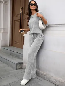 Chic grey ribbed knit loungewear set styled with white accessories and coffee