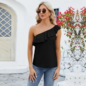 Elegant black one-shoulder top with ruffled trim shown on a model in a sunny setting