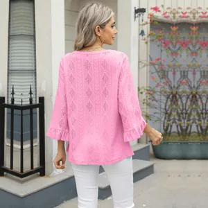 Back view of pink diamond jacquard hollow-out knit top with ruffled flared sleeves