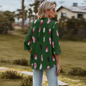 Back view of women's loose V-neck blouse featuring vibrant feather print and 3/4 sleeves