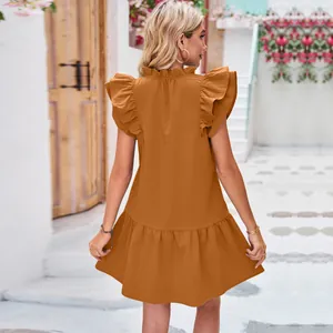 Back view of a brownish-orange solid dress with ruffled collar and flutter sleeves