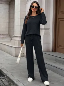 Chic dark grey ribbed knit loungewear set with long sleeve top and wide leg pants.