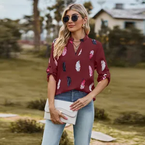 Elegant V-neck wine red blouse featuring colorful feather prints and a casual loose fit.