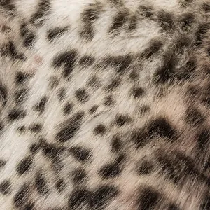 Detailed macro view showing the soft texture and pattern of faux fur leopard print fabric