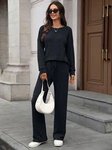 Elegant black knitted two-piece loungewear set with round neck top and wide-leg trousers