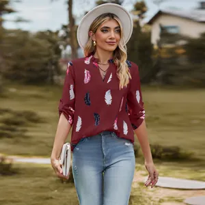 Elegant burgundy women's V-neck blouse showing detailed feather print patterns