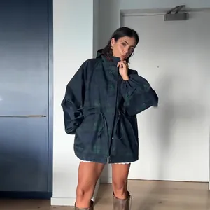 Stylish women's dark plaid hooded windbreaker jacket with drawstring waist and stand collar.