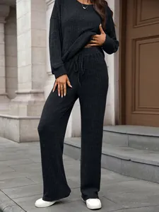 Close-up of black ribbed knit lounge set showing fabric texture and drawstring waist