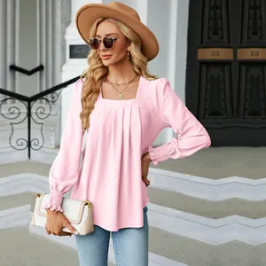Close-up showing the jacquard texture and pleated square neck of this pink blouse