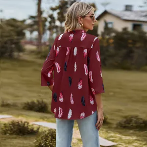 Back view detail of loose maroon shirt with elegant feather print and ruffled collar design