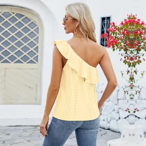 Back view of women's yellow one-shoulder ruffle sleeveless top in outdoor setting