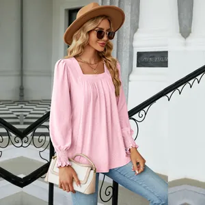 Detail view of pink jacquard pleated square neck long sleeve blouse with ruffled cuffs