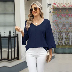 Detail view of navy blue V-neck top with diamond hollow jacquard and bell sleeves