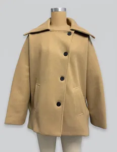 Macro view of a camel wool blend short coat with black buttons on a mannequin