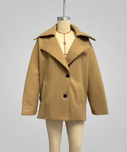 Detail of camel wool blend short coat with oversized lapels and black buttons