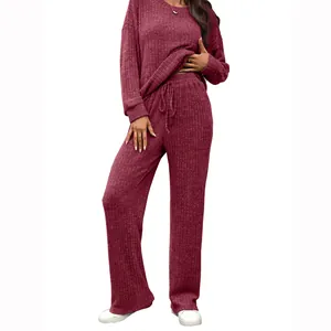 Two-piece wine red ribbed knit lounge set with round neck long sleeve top and pants.