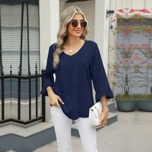 Model wearing navy V-neck t-shirt with diamond jacquard texture and ruffled bell sleeves