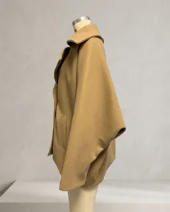 Side view detail showing the loose silhouette of a camel wool blend short coat for women