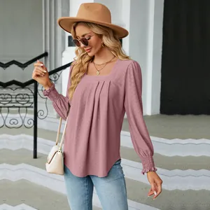 Close-up of the elegant pink jacquard texture and pleated square neck design on a blouse