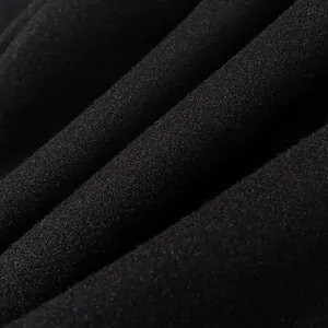 Macro close-up detail of high-quality black fabric texture for a long windbreaker coat