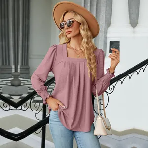 Detailed view of the square neckline and pleated texture on this pink long sleeve blouse