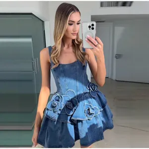 Detailansicht eines ärmellosen Jeanskleides mit 3D-Blumenverzierung und ausgestelltem Rock
