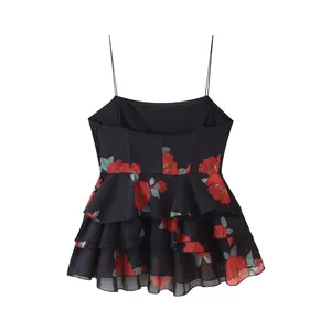 Close-up detail of black camisole top with elegant red rose print and tiered ruffles