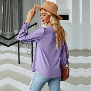 Back view detail of purple jacquard blouse with pleated cuffs and elegant brown hat