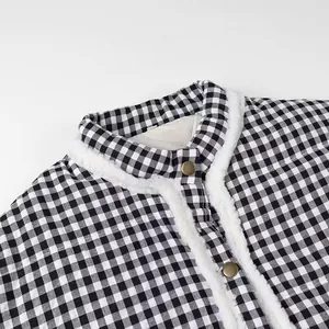 Close-up of women's black and white plaid jacket with white fleece trim and buttons