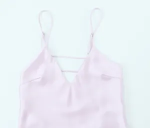 Close-up of elegant V-neck satin dress with adjustable straps and decorative chest detail
