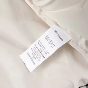 Detail view of 100% polyester care label on women's plaid jacket
