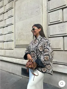 Model wearing printed stand-collar quilted jacket with geometric ethnic ikat patterns