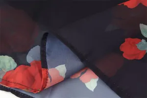 Detailed macro view of the floral print fabric texture and fine hemline stitching