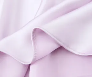 Macro shot of fine hemming and smooth satin fabric on a lilac midi dress