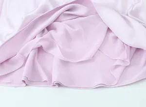 Close-up detail of the smooth lavender satin fabric and stitched hemline of a midi dress