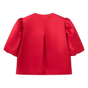 Back view detail of a vibrant red satin short-sleeved top with elegant puff sleeves