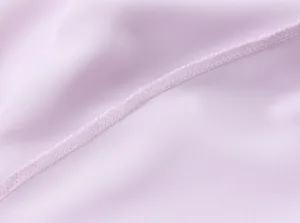 Close-up of neat stitching on light purple satin fabric of this backless midi dress