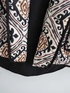 Close-up detail showing geometric tribal print and stitching on quilted padded jacket