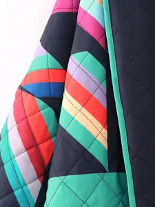 Close-up detail of a colorful quilted patchwork cotton jacket with geometric stripe pattern