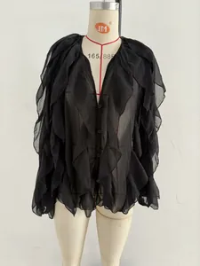 Front detail view of a black sheer layered long-sleeve blouse on a dress form mannequin