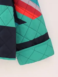 Detail showing the quilted texture and vibrant color block design of the padded jacket