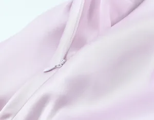 Detail view showing a high-quality concealed zipper on a luxury pink satin midi dress