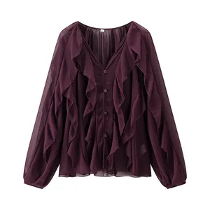 Macro view of elegant ruffled layers on dark purple V-neck chiffon long sleeve blouse.