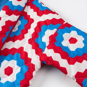 Close-up detail of the red blue and white geometric print on this quilted kimono jacket