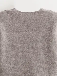 Detailed macro view of high-quality grey knitted blazer fabric with soft texture