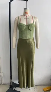 Detail view of green lace bustier top and matching satin maxi skirt set on a mannequin