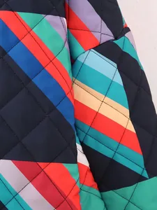 Close-up of a quilted jacket featuring a vibrant multicolor geometric stripe pattern.