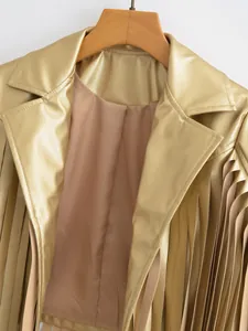 Close-up detail of metallic gold faux leather jacket with stylish long fringe accents